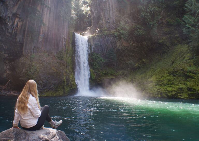 Myself sitting on a rock in front of a waterfall near Bend, Oregon.