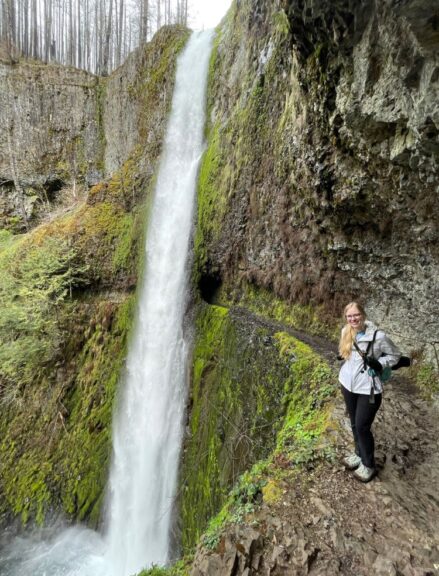 Myself wearing a backpack and clothes underneath Tunnel Falls.