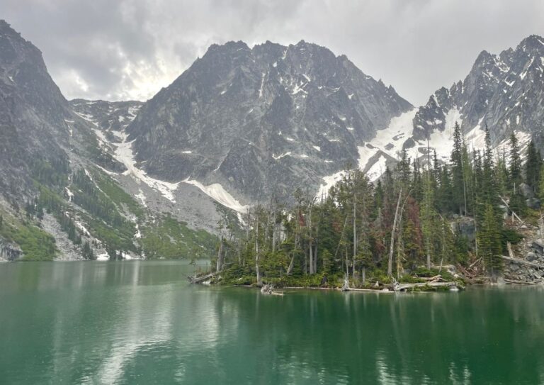 Dragontail Peak sanding tall behind Colchuck Lake which can be reached by a hike.