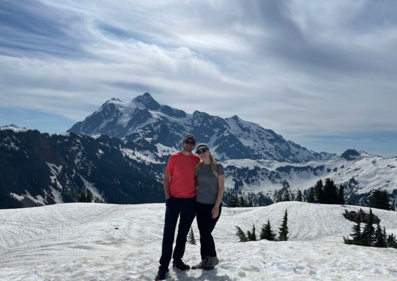 Tyler and I standing near Mount Shuksan wearing our hiking gear.