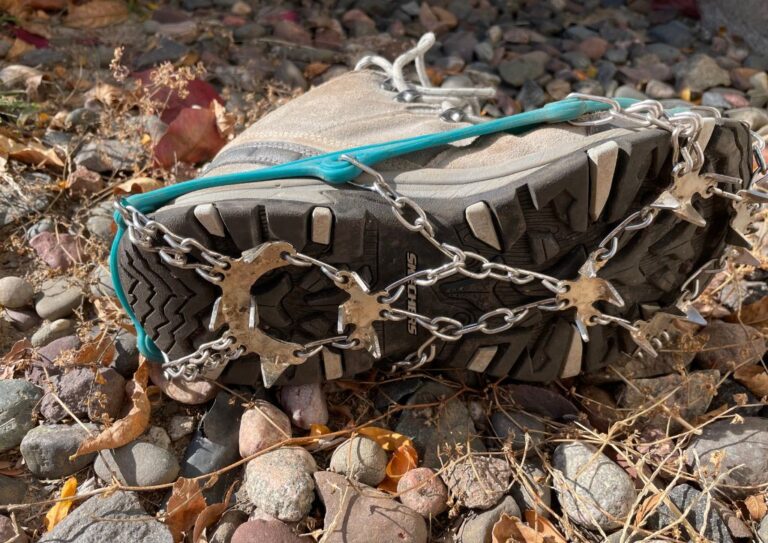 A boot with microspikes for hiking on the ground.