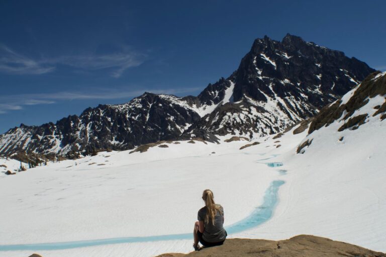 Myself sitting in front of Lake Ingalls, a Washington hike with a lake.