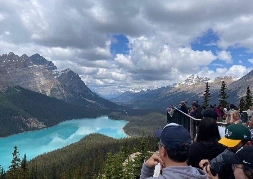 A platform with a large crowd near Peyto Lake in the mountains of Canada.