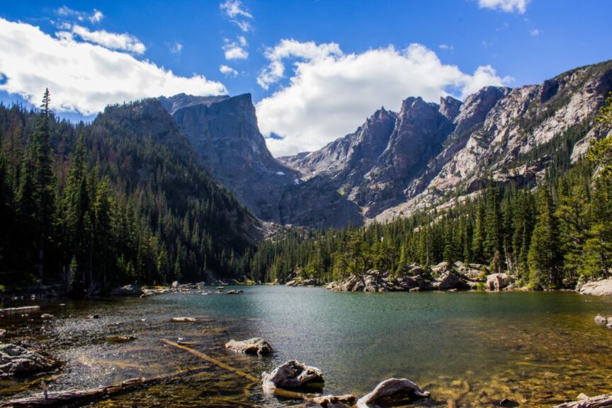 Mountains in Rocky Mountain National Park with a lake in the foreground.